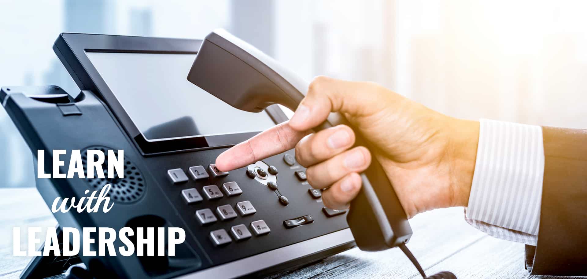 man-holding-voip-phone-and-dialing